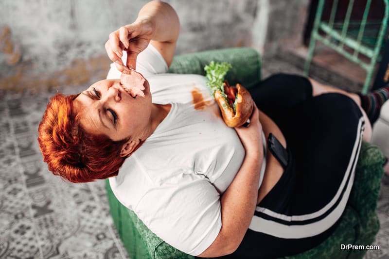 Overweight woman eats sandwich, bulimic, obesity problem. Unhealthy lifestyle, fat female