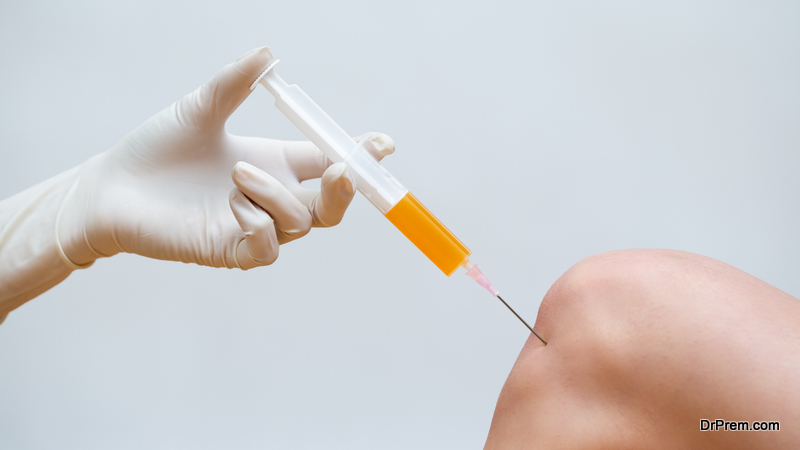 Doctor doing stem cell therapy on a patient knee after the injury using syringe with needle