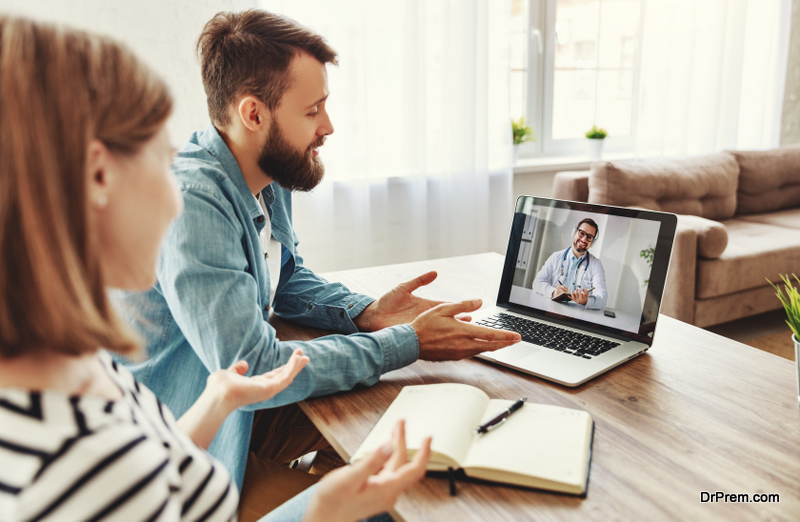 Young man and woman gesticulating and speaking with male doctor psychologist while making video call to psychotherapy clinic from home
