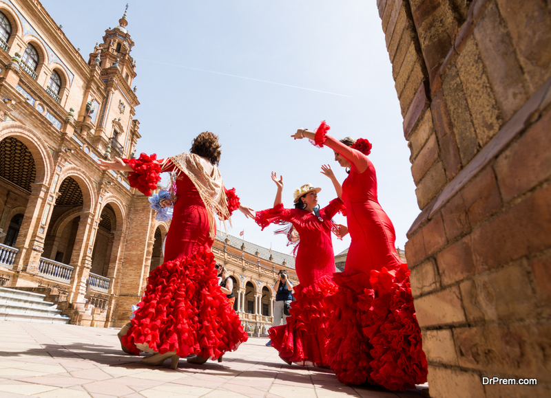 Young women dance flamenco on Plaza de Espana during famous Feria festival