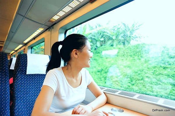 young woman looking out of the window in train