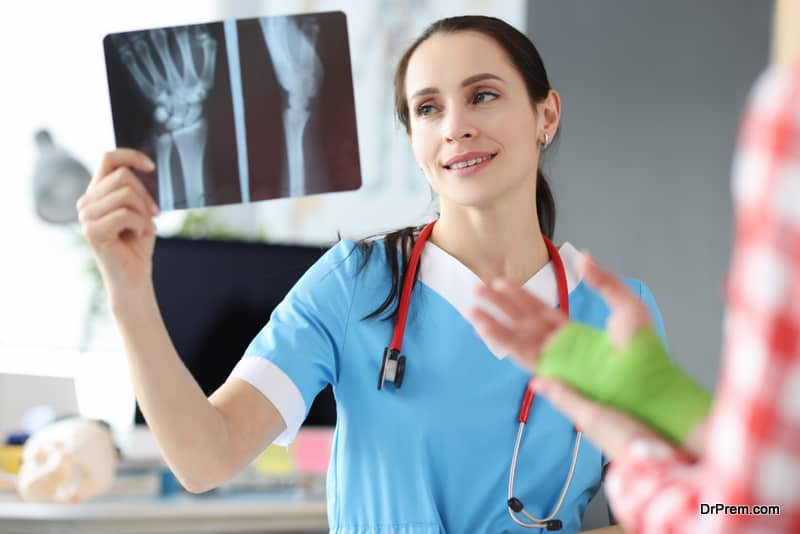 Doctor examines patient hand injury on an X-ray