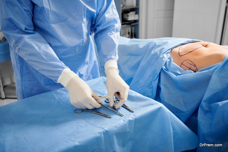  Patient with marks on skin lying on medical bed while doctor preparing scissors, forceps and scalpels