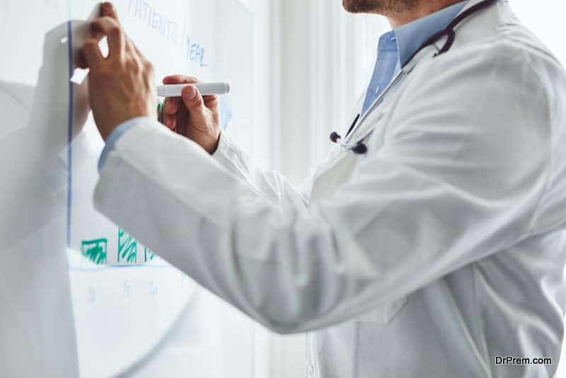 Doctor draws statistics of disease on white board