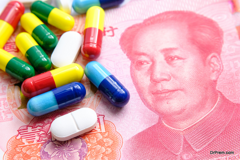 Pile of different colourful pills placed next to 100 yuan banknotes