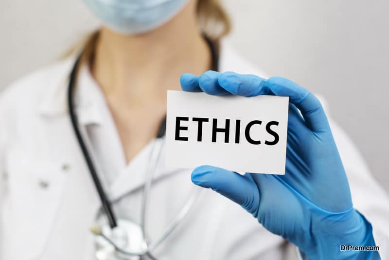 Doctor with stethoscope holding a card with text Ethics