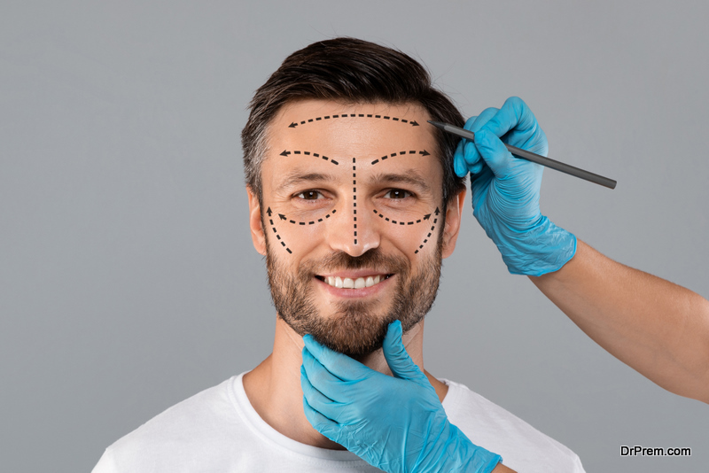 Surgeon hands making marks on smiling man face. Aesthetic Cosmetology