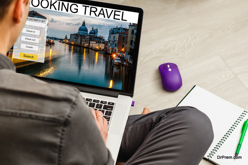 Man using a laptop and smartphone online travel bookings