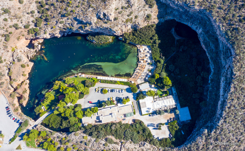 Athens Greece Aerial drone view of Vouliagmeni lake, thermal mineral water with healing abilities, luxury health spa, sunny summer day