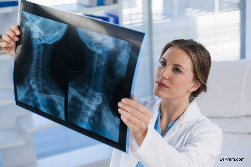 Female doctor examining x-ray report in clinic