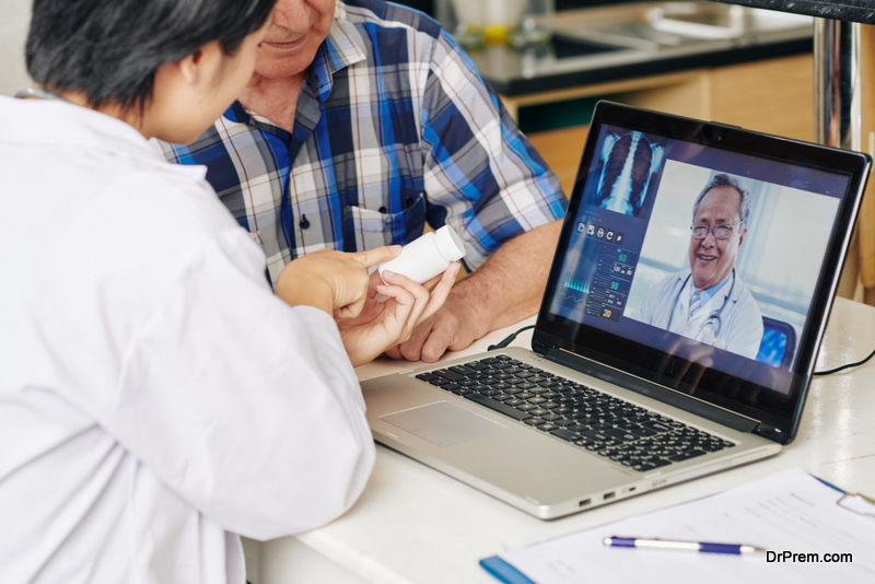 Medical nurse consulting with general practitioner via video call and recommending tablets to senior patient