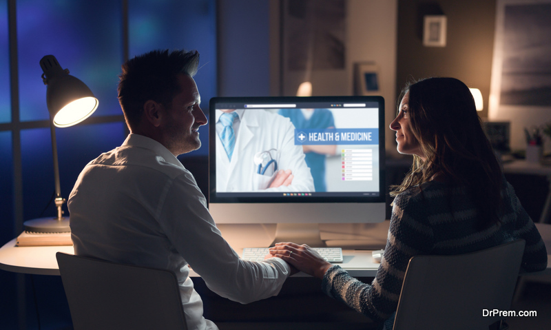 Young happy couple holding hands and searching medical services online