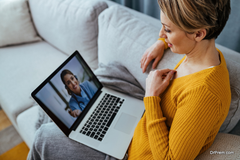 Woman using laptop and having video call with her doctor
