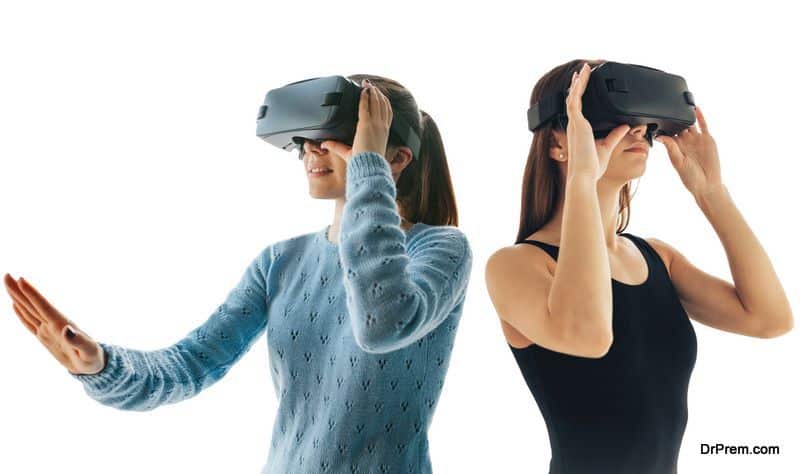 Two young girls in virtual reality glasses on a white background.. The concept of modern technologies and technologies of the future. VR glasses.