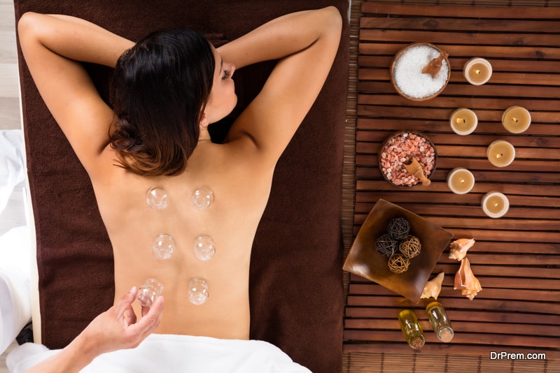 High Angle View Of A Relaxed Young Woman Receiving Cupping Treatment On Back