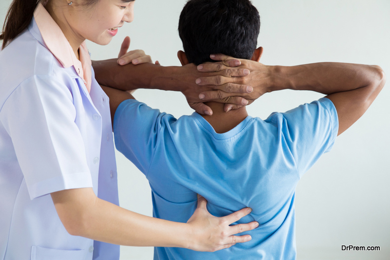 Physiotherapist doing healing treatment on man's back.Back pain