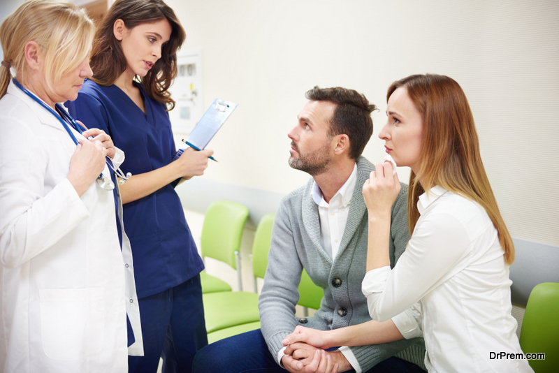 upset couple talking to medical staff