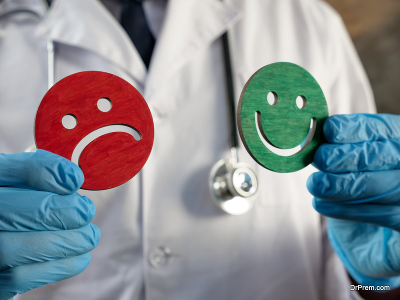  Doctor holds joyful and sad emoticons