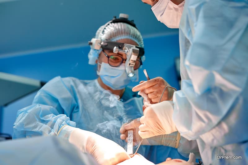 Surgeon performing cosmetic surgery in hospital operating room