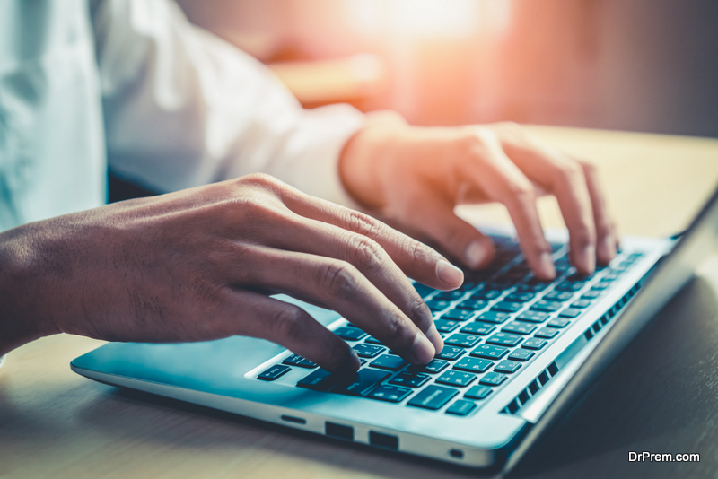 man typing on computer keyboard