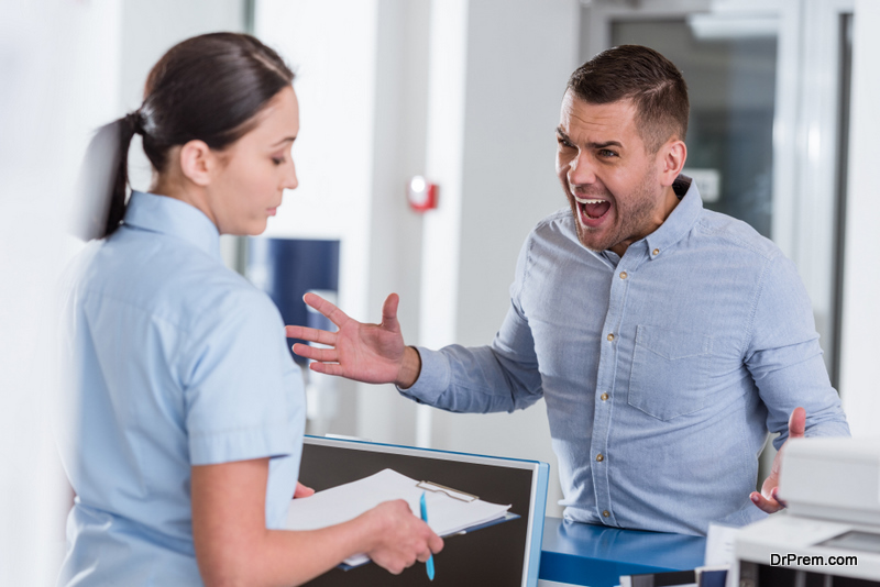 Aggressive man yelling at nurse in clinic 