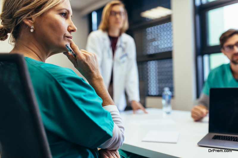 Female medical professional in meeting with colleagues. Doctor during meeting in the conference room.