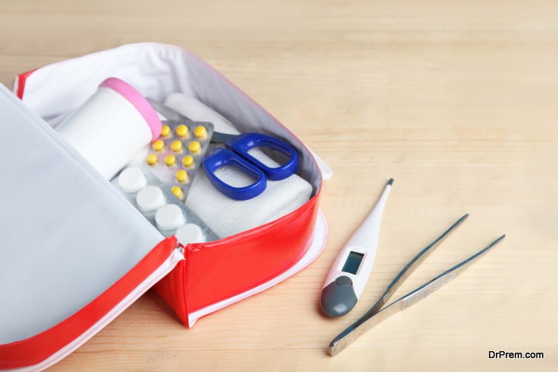 First-aid kit with medicines on a wooden background.