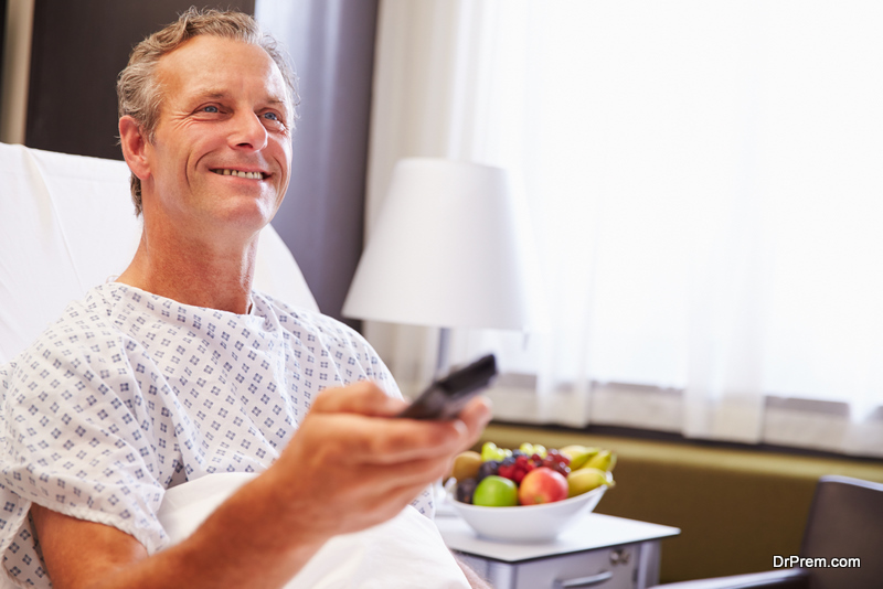 Male Patient In Hospital Bed Watching Television