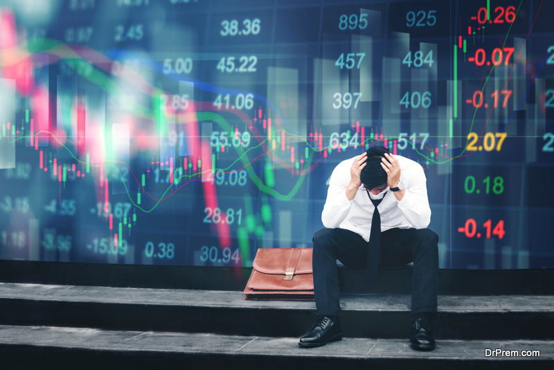 Tired or stressed businessman sitting on the walkway in panic digital stock market financial 