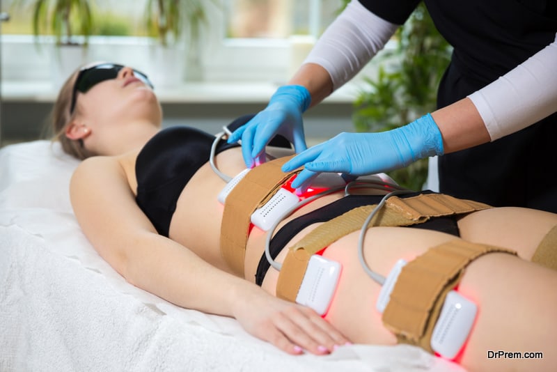 Woman receiving slimming lipo laser therapy in spa