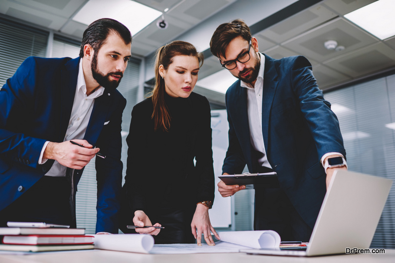 Successful people working together in office discussing and making notes