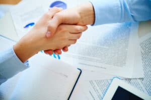 The Death of Paper Consent: AI Rewrites Patient Trust in Medical Tourism close up handshake