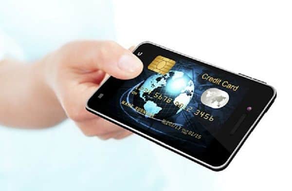 hand holding mobile phone with credit card screen