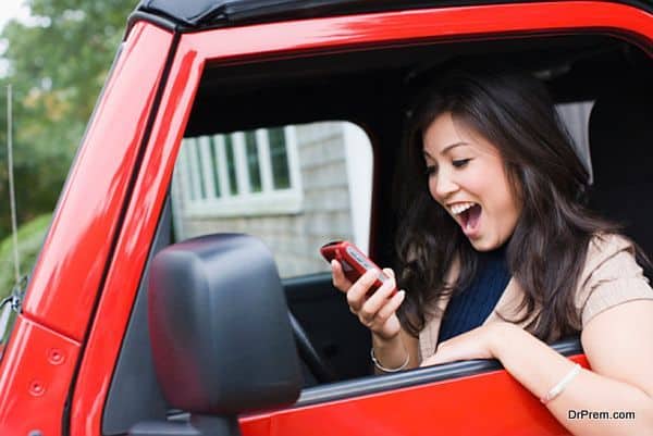 Woman holding mobile phone and looking surprised