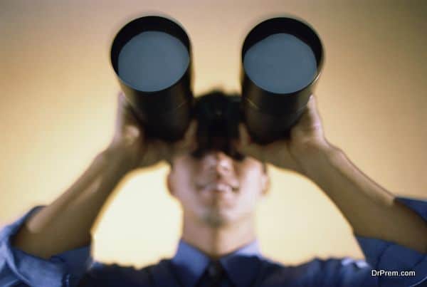 Businessman looking through a pair of binoculars