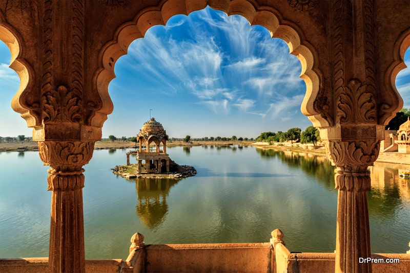 Indian landmark Gadi Sagar - artificial lake view through arch. Jaisalmer, Rajasthan, India