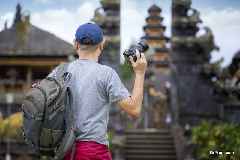Asian photographer travel in old temple in Bali 