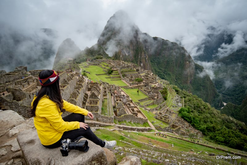  Asian woman traveler looking at Machu Picchu