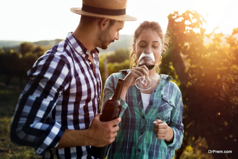 Beautiful woman tasting wine in wine grower vineyard