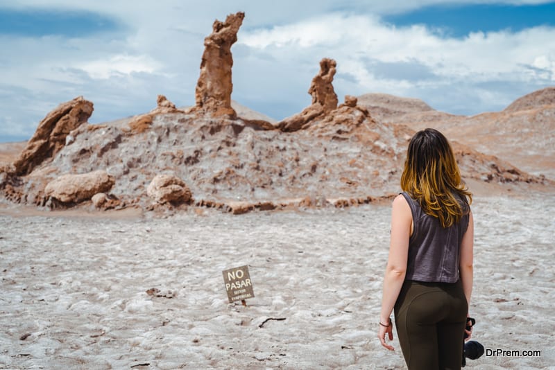Young Female Tourist at Las Tres Marias Rock Formation in the Moon Valley, Atacama Desert, Chile, South America