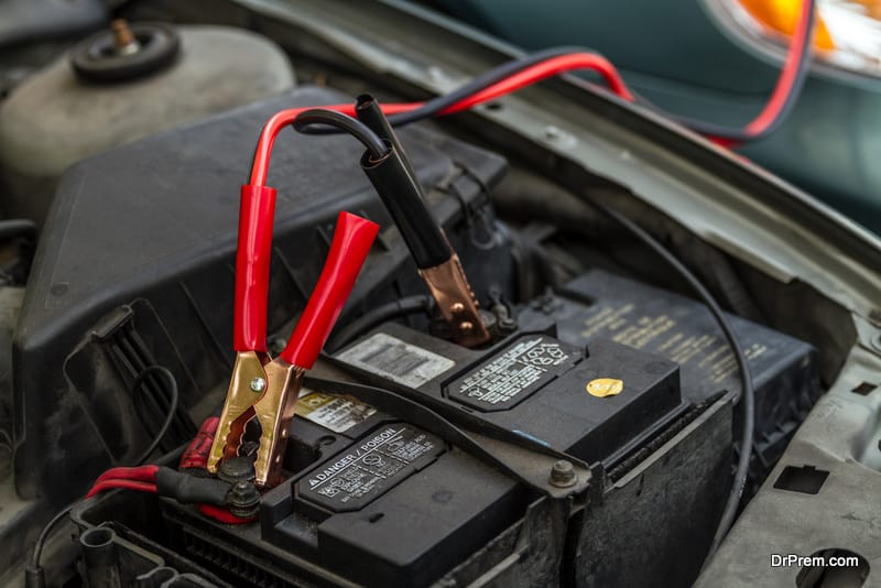 Car Battery with Jumper Cables giving load to another car battery