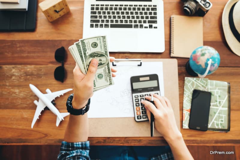 tourist counting cash to spend during his vacation, planning budget