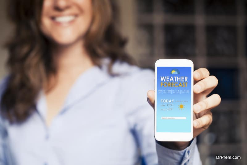  woman showing a mobile phone with weather forecast