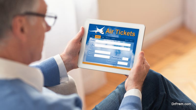 Buying Air Tickets For Vacation Using Laptop Sitting On Sofa At Home
