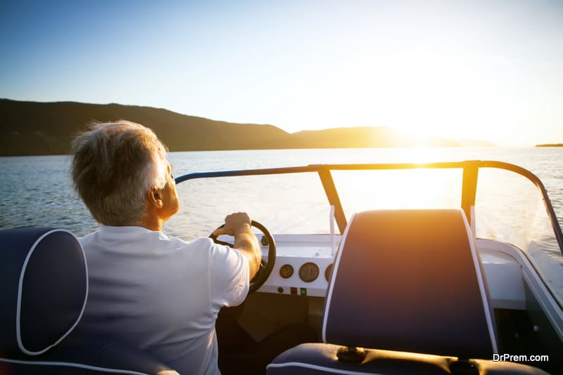 mature man driving speedboat