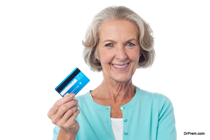 Senior woman displaying her cash card