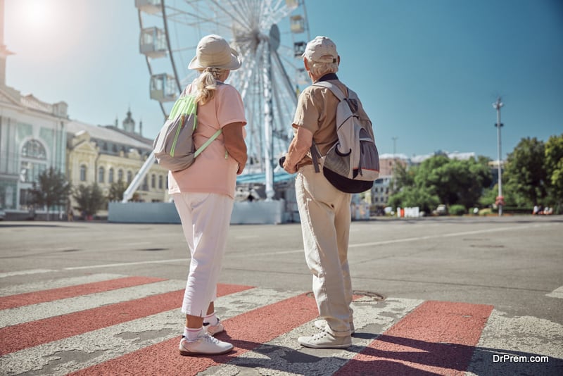 Tourist couple standing at the pedestrian crossing