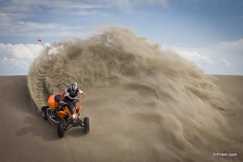 Quad rider in sand dunes roost