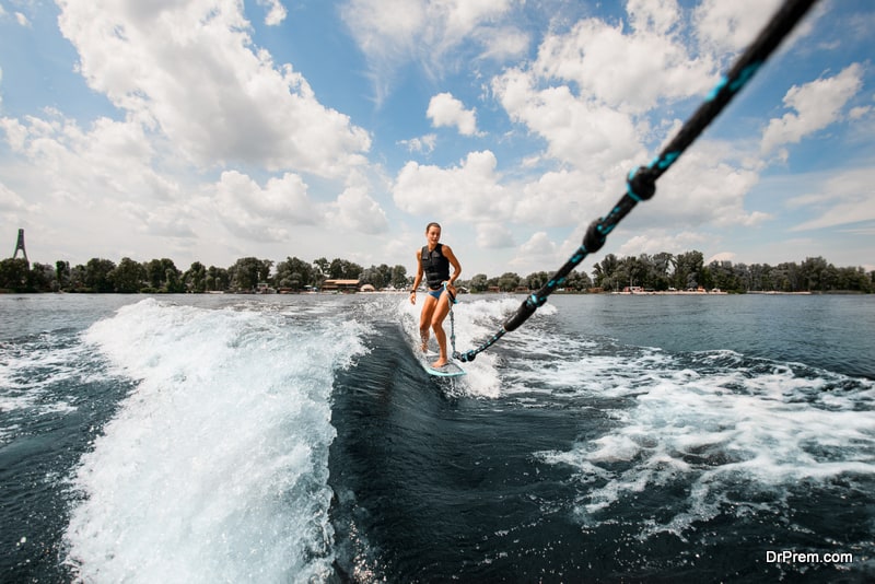 woman-who-holds-rope-and-riding-on-wake-board