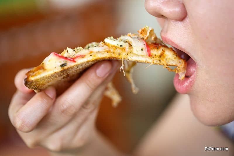 woman eating flavored pizza